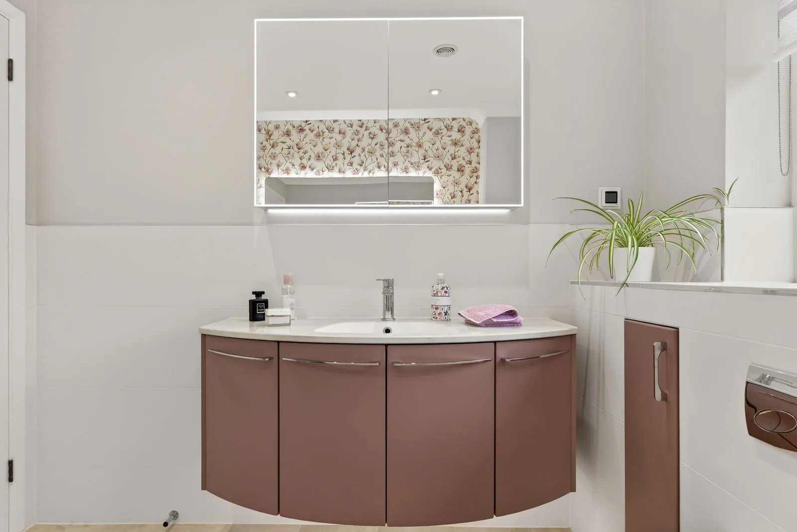 This bathroom features the elegant Utopia furniture collection in a soft blush finish, creating a warm and contemporary focal point.