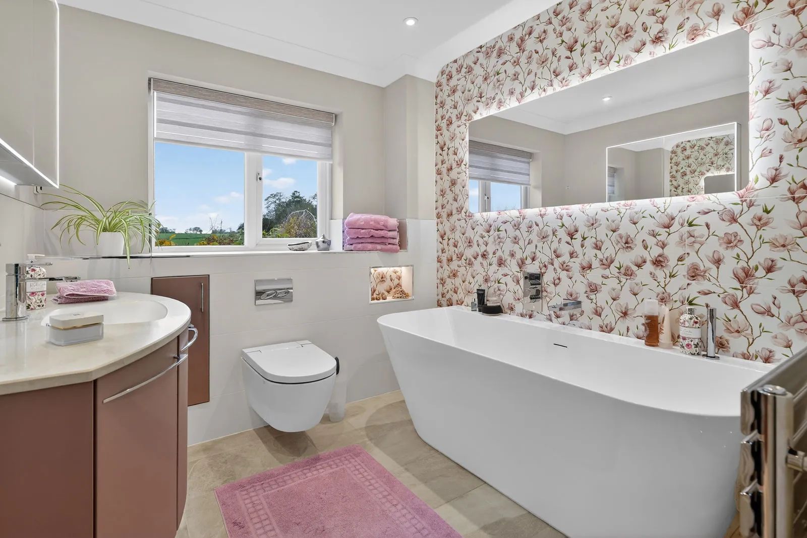 This bathroom features the elegant Utopia furniture collection in a soft blush finish, creating a warm and contemporary focal point.